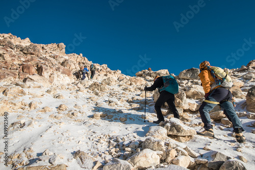 group of mountaineers walking through the mountain full of snow and rocks in the morning in Iztaccihuatl - Popocatepetl National Park photo
