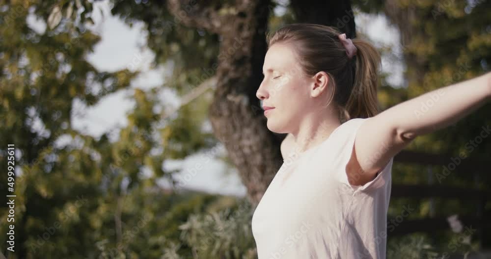 Woman practice yoga outdoors tree nature breathe meditate in close up Woman practice yoga outdoors tree nature breathe meditate in close up