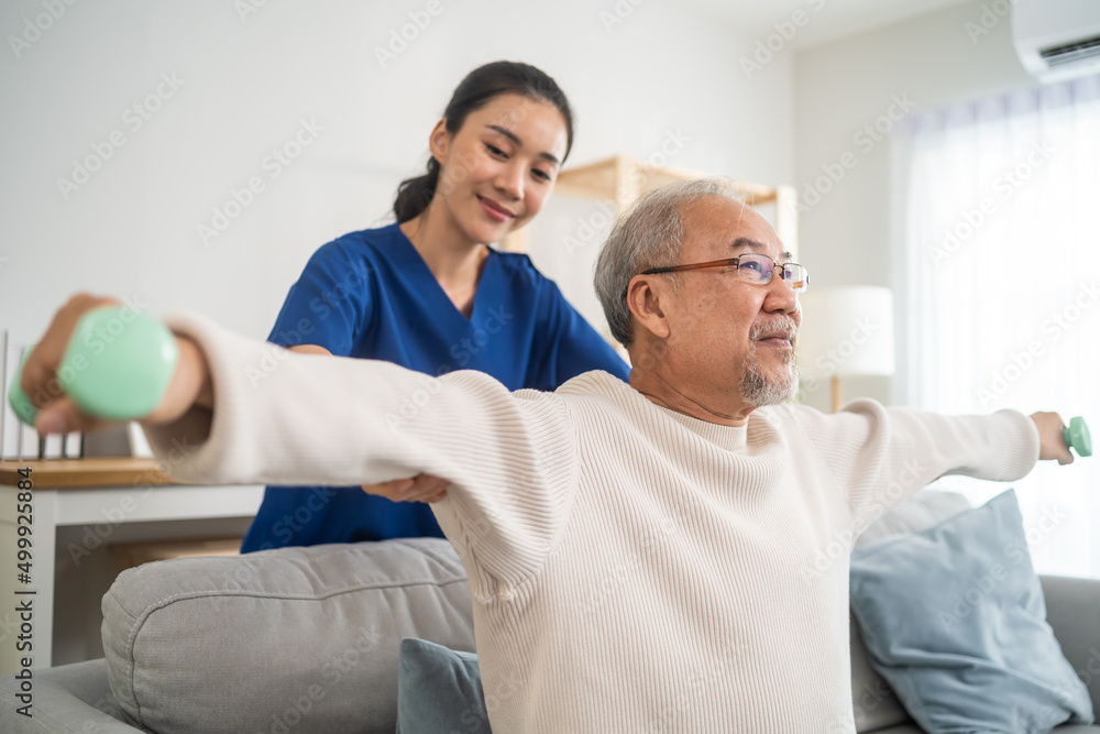 Obraz premium Asian older aged man doing physiotherapist with support from nurse. 