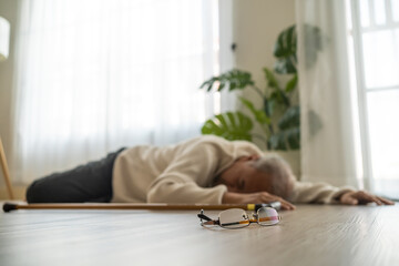 Asian senior male falling on the ground while walk with walker at home