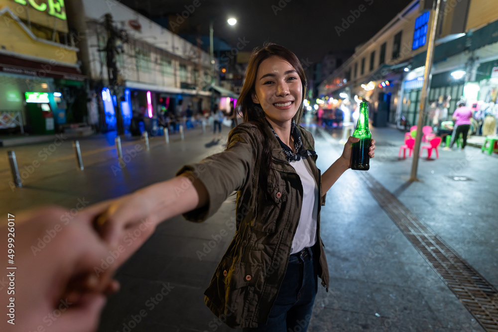 Portrait of Asian woman traveler hold boyfriend's hand, walk on street Portrait of Asian woman traveler hold boyfriend's hand, walk on street