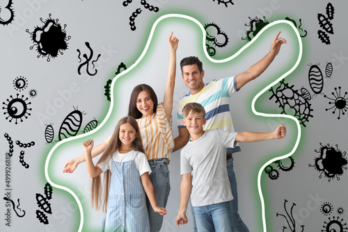 Healthy family with strong immunity on grey background. Protection against germs, bacteria and viruses photo
