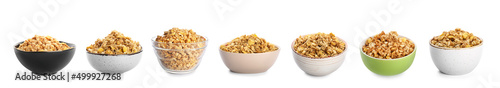 Set of bowls with tasty granola on white background