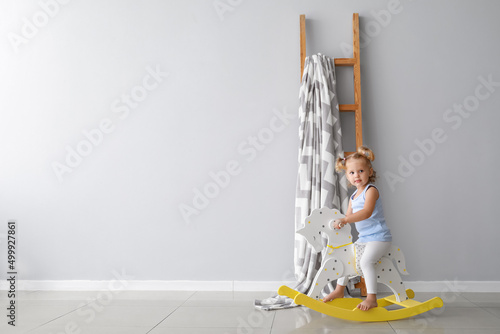 Adorable baby girl with roc...