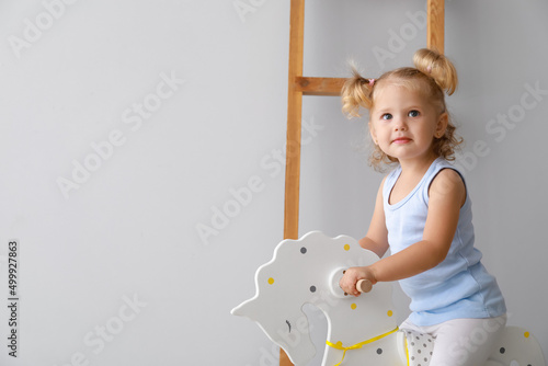 Adorable baby girl with roc...