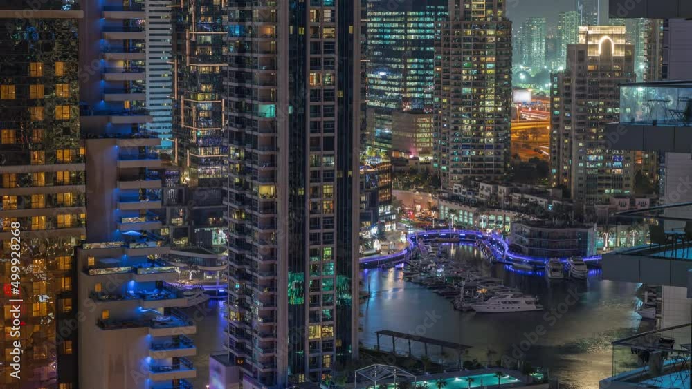 Aerial view on Dubai Marina skyscrapers and the most luxury yacht in harbor night timelapse, Dubai, United Arab Emirates Aerial view on Dubai Marina skyscrapers and the most luxury yacht in harbor night timelapse, Dubai, United Arab Emirates