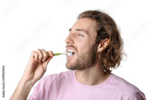 Handsome young man brushing...