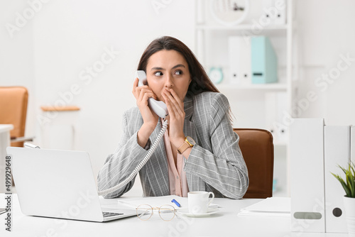 Young secretary gossiping b...