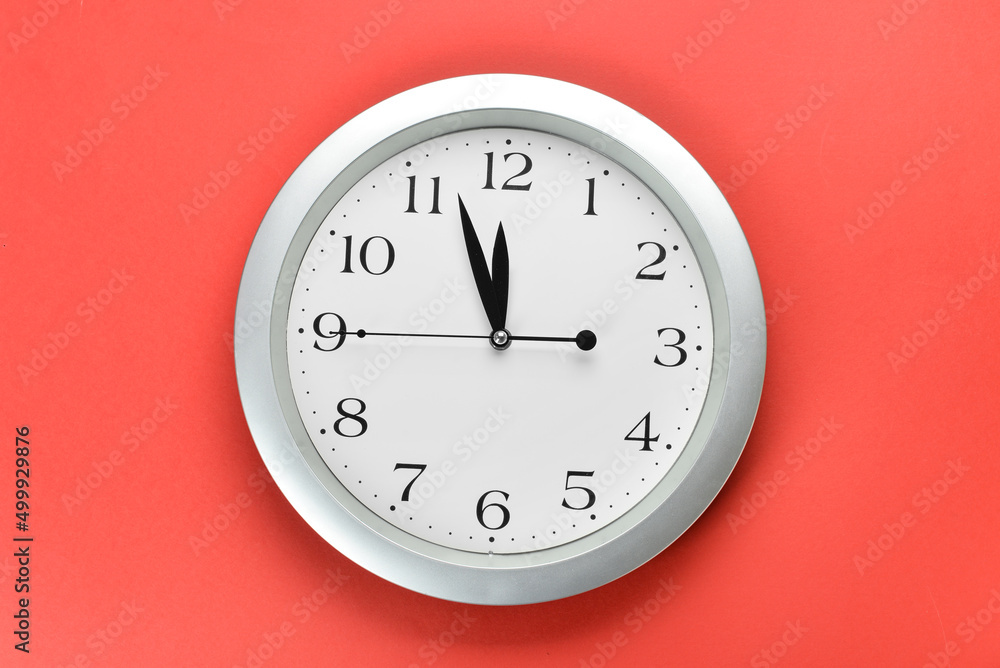 New modern clock on red background New modern clock on red background