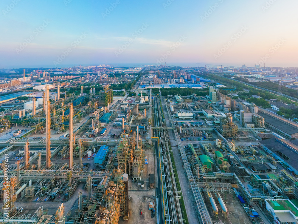 Aerial view of petrochemical oil refinery and sea in industrial engineering concept in Bangna district at night, Bangkok City, Thailand. Oil and gas tanks pipelines in industry. Modern metal factory. Aerial view of petrochemical oil refinery and sea in industrial engineering concept in Bangna district at night, Bangkok City, Thailand. Oil and gas tanks pipelines in industry. Modern metal factory.