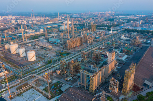 Aerial view of petrochemical oil refinery and sea in industrial engineering concept in Bangna district at night  Bangkok City  Thailand. Oil and gas tanks pipelines in industry. Modern metal factory.