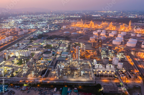 Aerial view of petrochemical oil refinery and sea in industrial engineering concept in Bangna district at night, Bangkok City, Thailand. Oil and gas tanks pipelines in industry. Modern metal factory. © Sathit Trakunpunlert