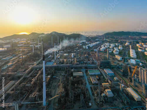 Aerial view of petrochemical oil refinery and sea in industrial engineering concept in Bangna district at night  Bangkok City  Thailand. Oil and gas tanks pipelines in industry