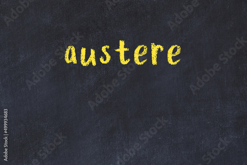 Foto Black chalkboard with inscription austere on in