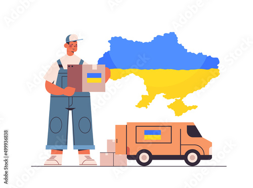deliveryman giving help box with Ukraininan flag to refugees humanitarian aid material assistance governmental help