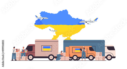 volunteers giving help boxes with Ukraininan flag to refugees humanitarian aid material assistance governmental help