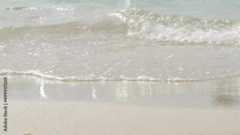Transparent clean waves of ocean or sea roll on the sandy shore beach. Summer holidays, relaxation and travel Transparent clean waves of ocean or sea roll on the sandy shore beach. Summer holidays, relaxation and travel
