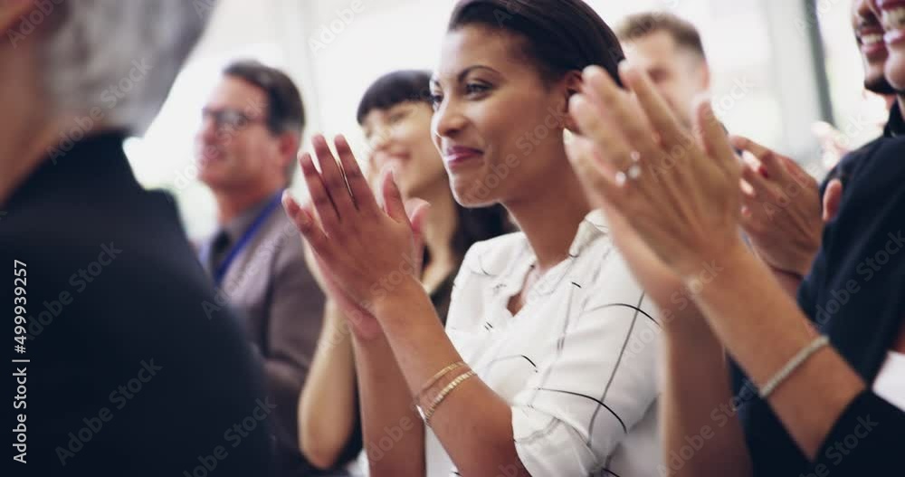 Expand your knowledge. 4k footage of a group of businesspeople clapping hands while sitting in a conference.