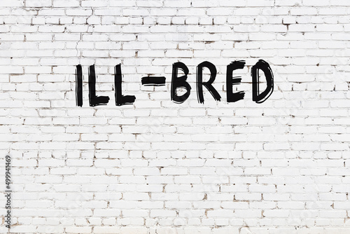 Inscription ill-bred painted on white brick wall