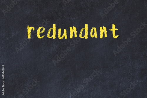 College chalk desk with the word redundant written on in