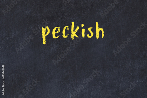 College chalk desk with the word peckish written on in