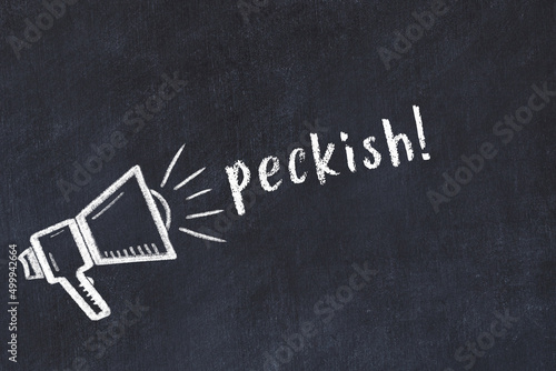 Chalk loudspeaker and inscription peckish on black chalkboard