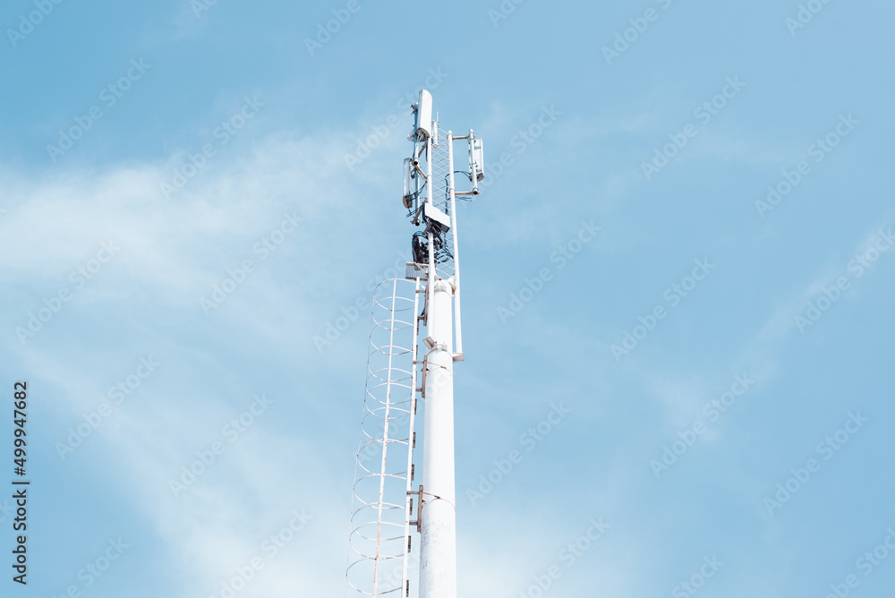 Modern radio tower for mobile and satellite communications against blue sky on clear day, outdoors. Telecommunication technologies Modern radio tower for mobile and satellite communications against blue sky on clear day, outdoors. Telecommunication technologies