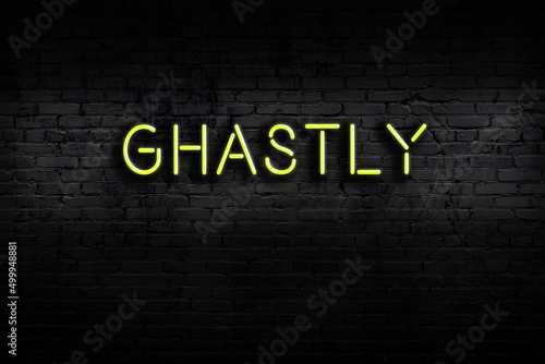 Принти на полотні Neon sign. Word ghastly against brick wall. Night view