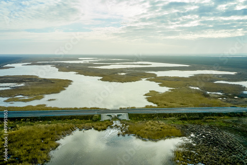 asphalt road and bridge over a lake in the steppe photo from a quadcopter landscape © сергей тарануха