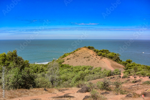 Panoramic view of beautiful blue Arabian Sea and a lush adjacent hill from the top of Chapora Fort  Goa India.