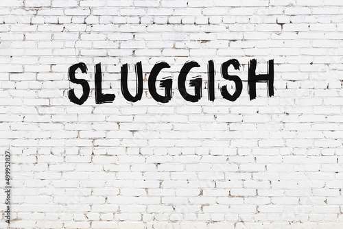 Photography White wall with black paint inscription sluggish on it