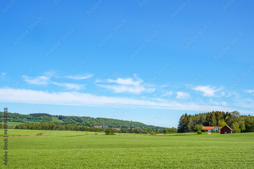 Rural view with a farmhouse on a field