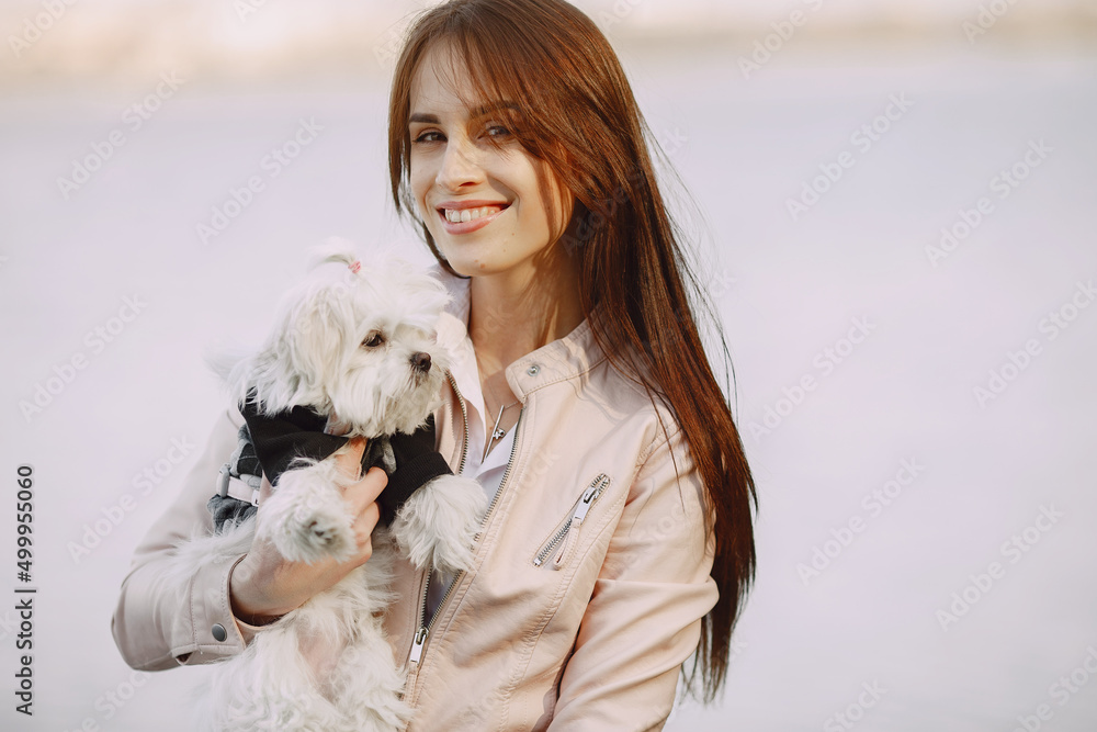 Brunette in a forest walks with cute dog Brunette in a forest walks with cute dog