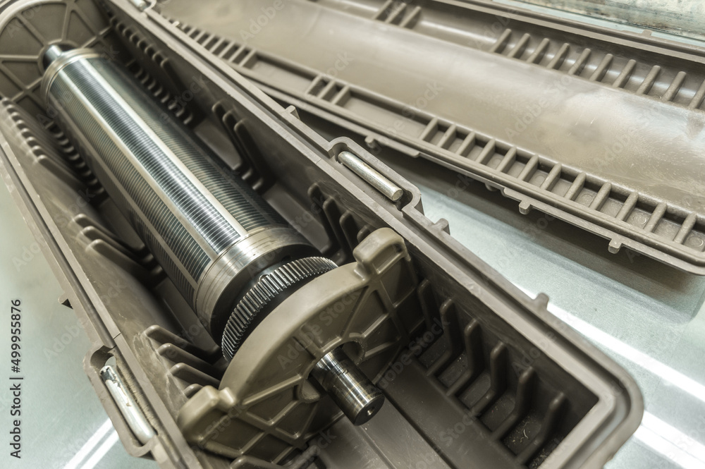 Used magnetic cylinder for rotary printing machine in plastic box. Magnetic shaft for die mounting. Selective focus Used magnetic cylinder for rotary printing machine in plastic box. Magnetic shaft for die mounting. Selective focus