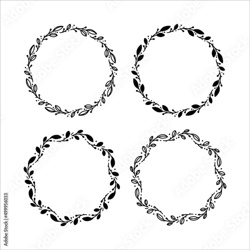 Set of 4 hand drawn spring wreaths isolated on white background, vector. Outline and silhouette frames of leaves. Doodle style.Collection of floral monogram frames.