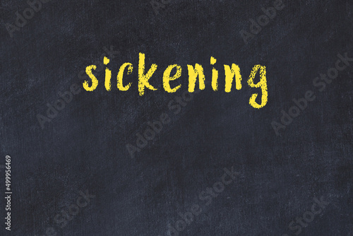 College chalk desk with the word sickening written on in