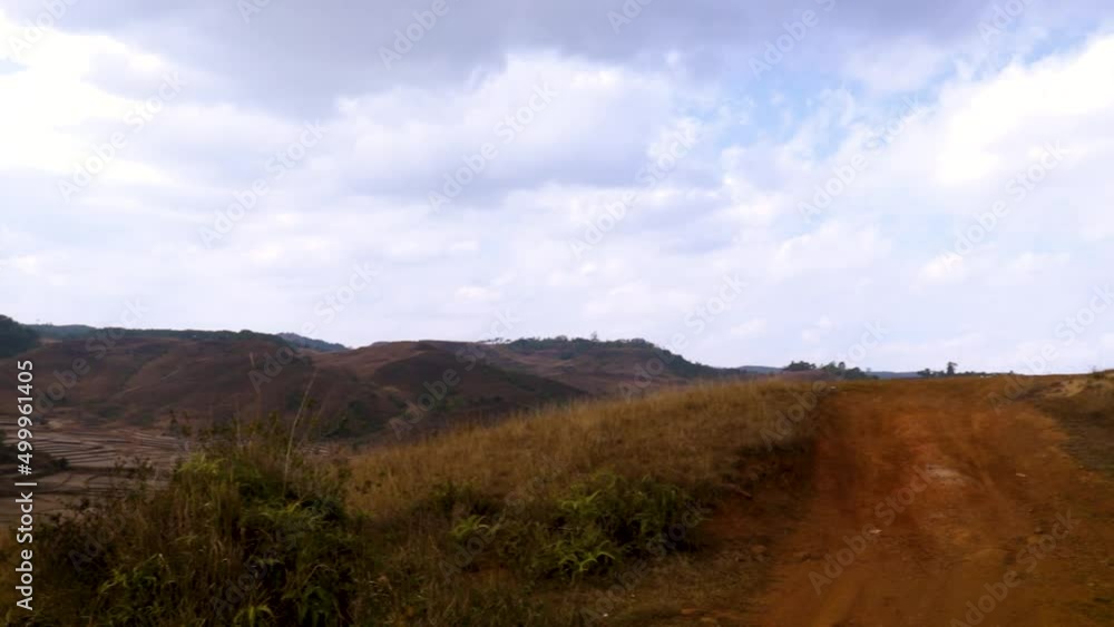 isolated mountain range with dramatic sky and vacant road at evening isolated mountain range with dramatic sky and vacant road at evening