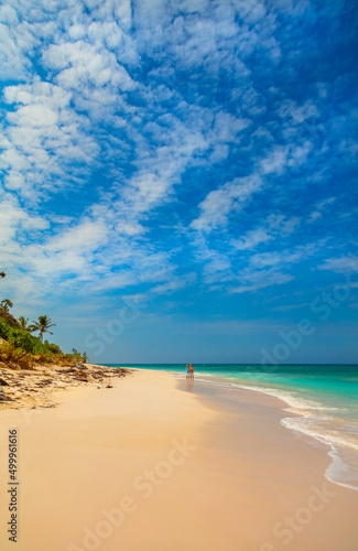 Loving mature Caucasian couple walking on sandy beach