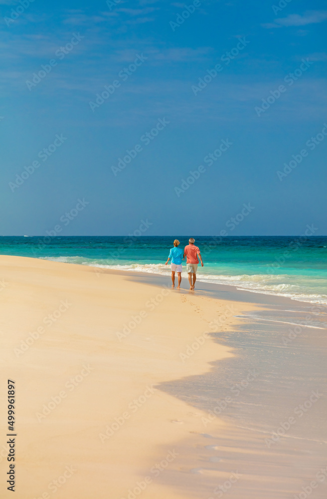 Loving mature couple enjoying romantic beach walks Bahamas