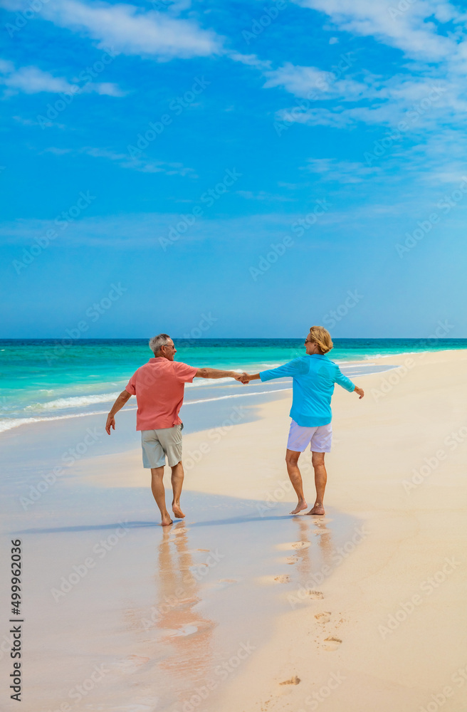 Mature couple enjoying freedom outdoors on island vacation Mature couple enjoying freedom outdoors on island vacation