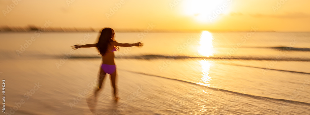 Panoramic motion blur Asian female running through ocean