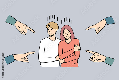 Numerous hands pointing at scared unhappy couple feeling unwell for blaming and guilt. Society shaming young man and woman for relationships. Discrimination. Vector illustration. 