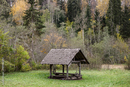 Wood construction picnic table with roof.