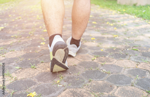 Closeup man walking towards on the road side. Step and walk concept.