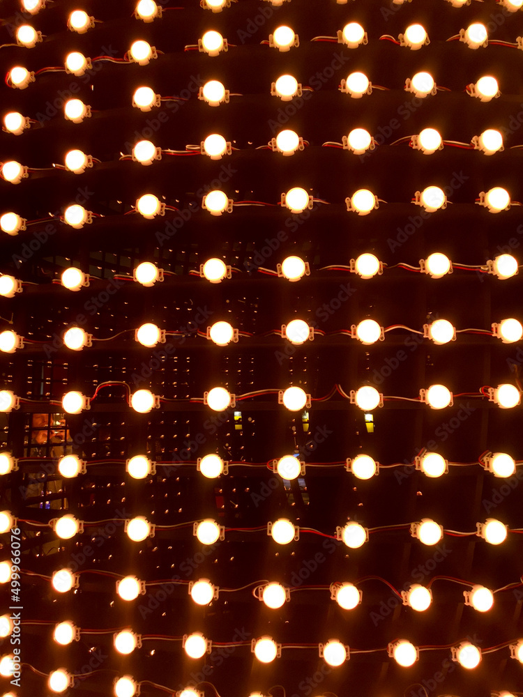 Red light bulbs shine as an abstract background.