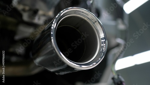Closeup of clean car muffler. New generation of sportive mufflers. Double Car Exhaust Pipe chromed made of stainless steel. Powerful exhaust pipe from the car. photo