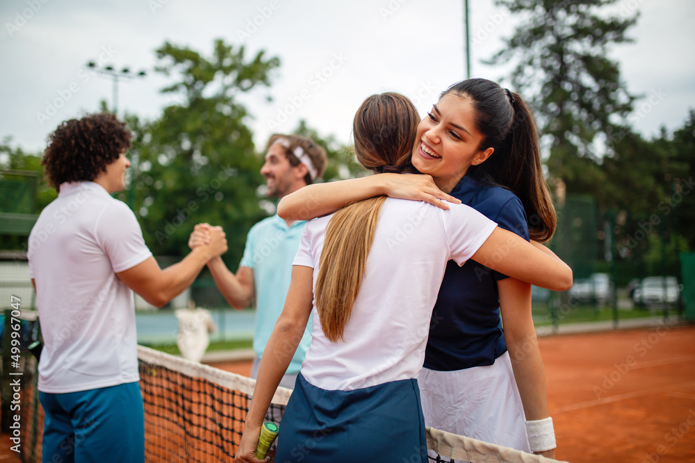 Group of tennis people players giving a handshake after a match Group of tennis people players giving a handshake after a match