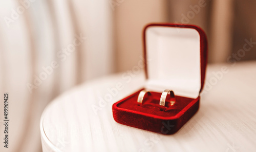 Wedding gold rings in red velvet box on the table © Daria Lukoiko