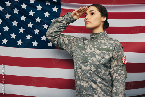 American soldier saluting against the United States flag