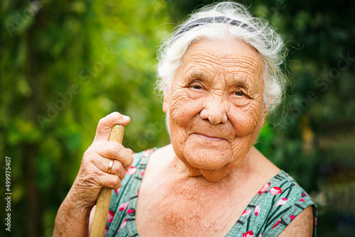 close up portrait of a senior woman in a garden. Very old lady of eighty years old outdoor in summer